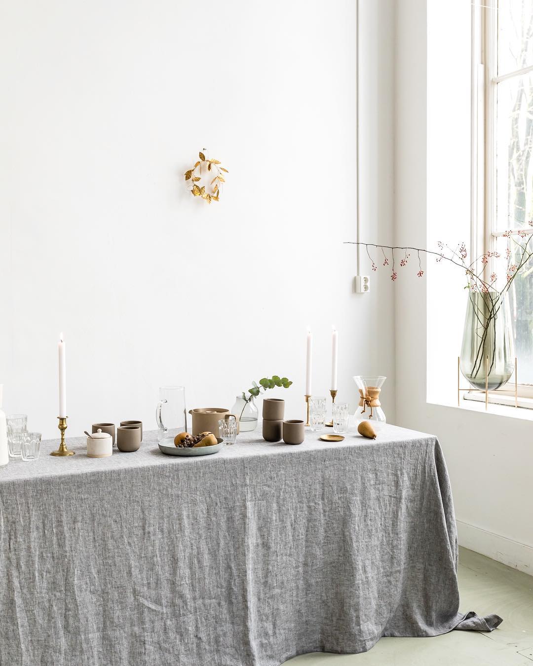 Gray and brownish table setting with candle holders and a chemex carafe